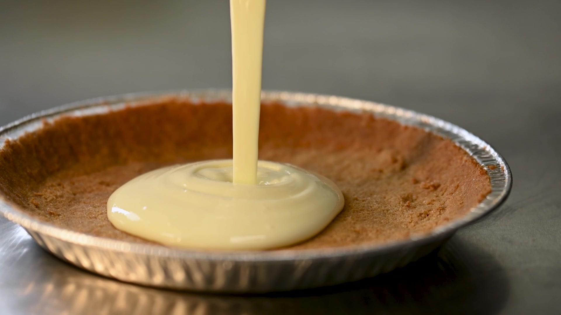Creamy key lime pie filling poured into a pie shell